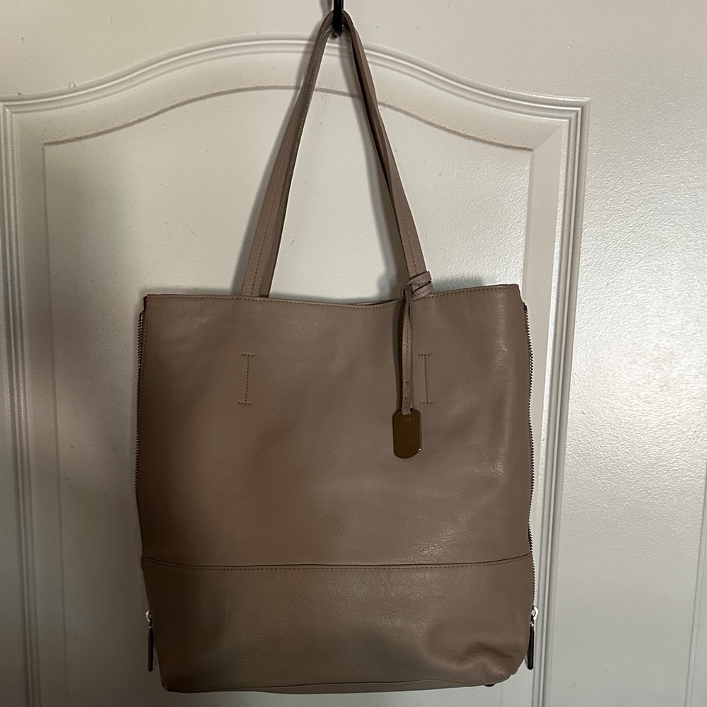 Furla shoulder beige bag with red on each side of bag with zippers.
